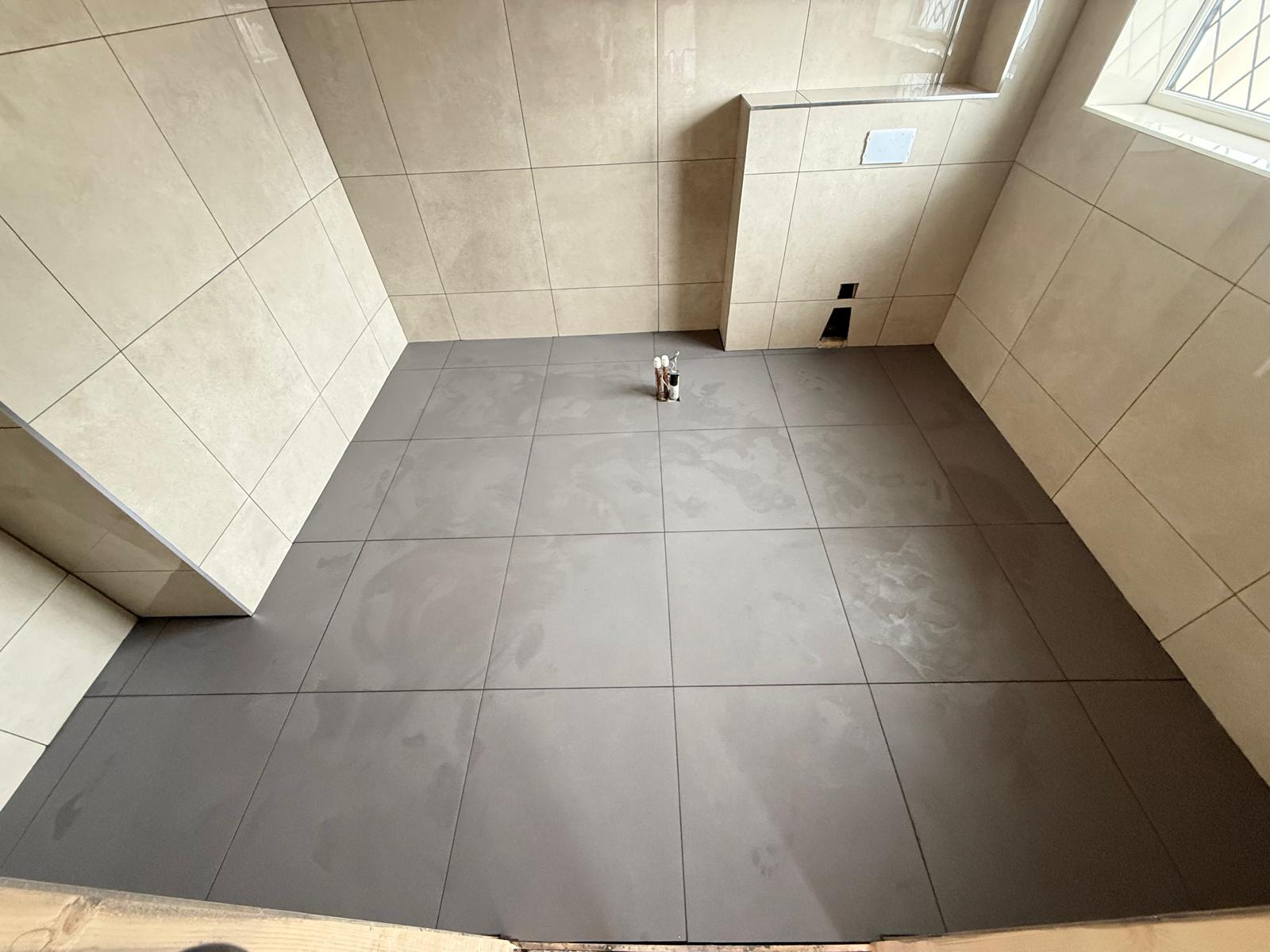 Large format floor and wall tiling completed in a bathroom