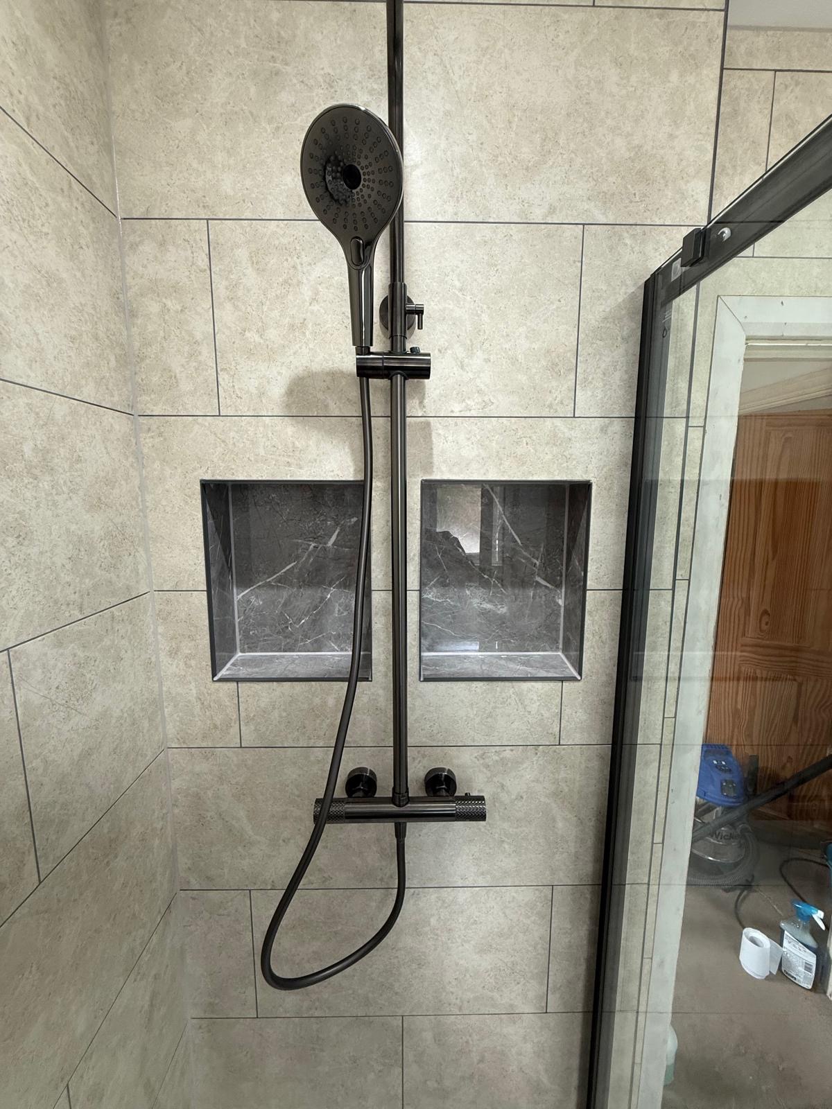 Shower with twin tiled niches and gunmetal rainfall shower fittings